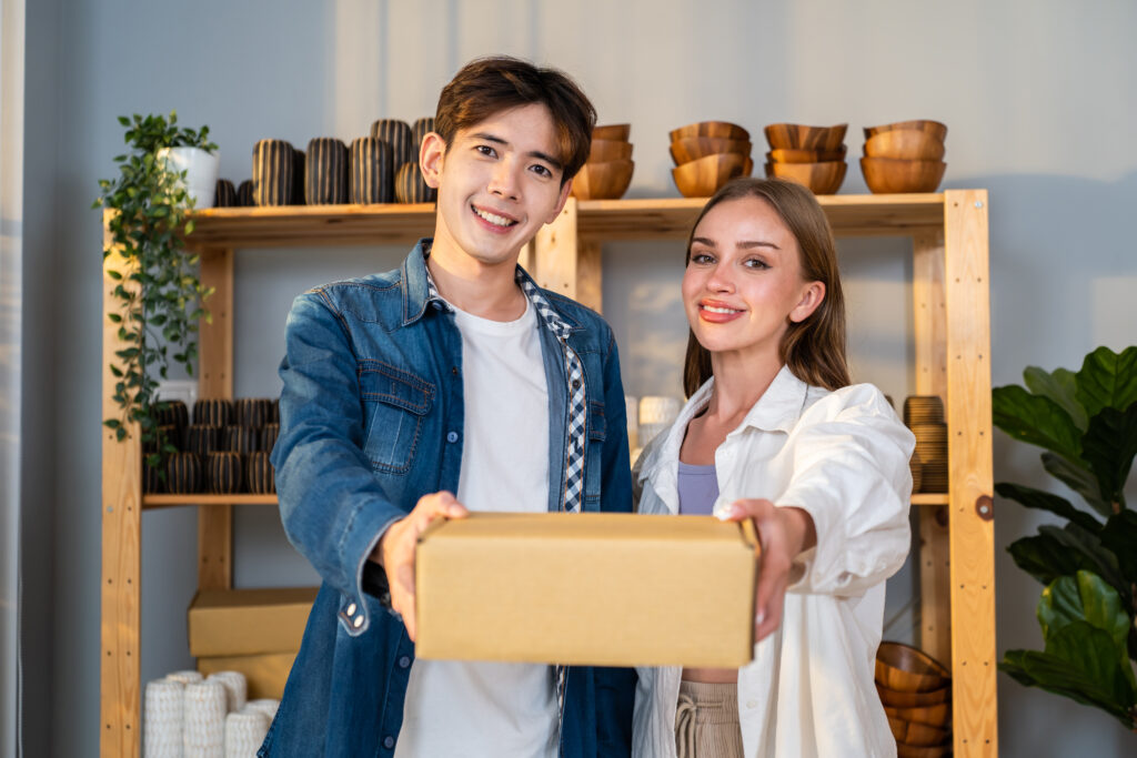 A man and woman holding a package delivered by Ribrad
